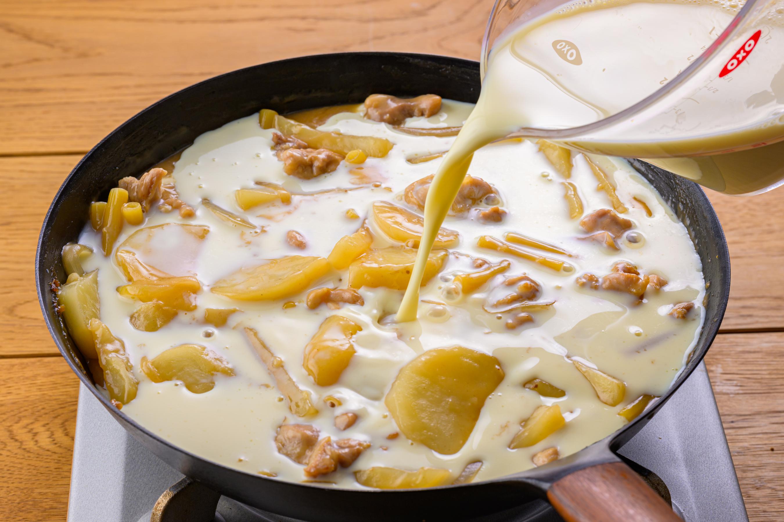 Adding soy milk to the pan