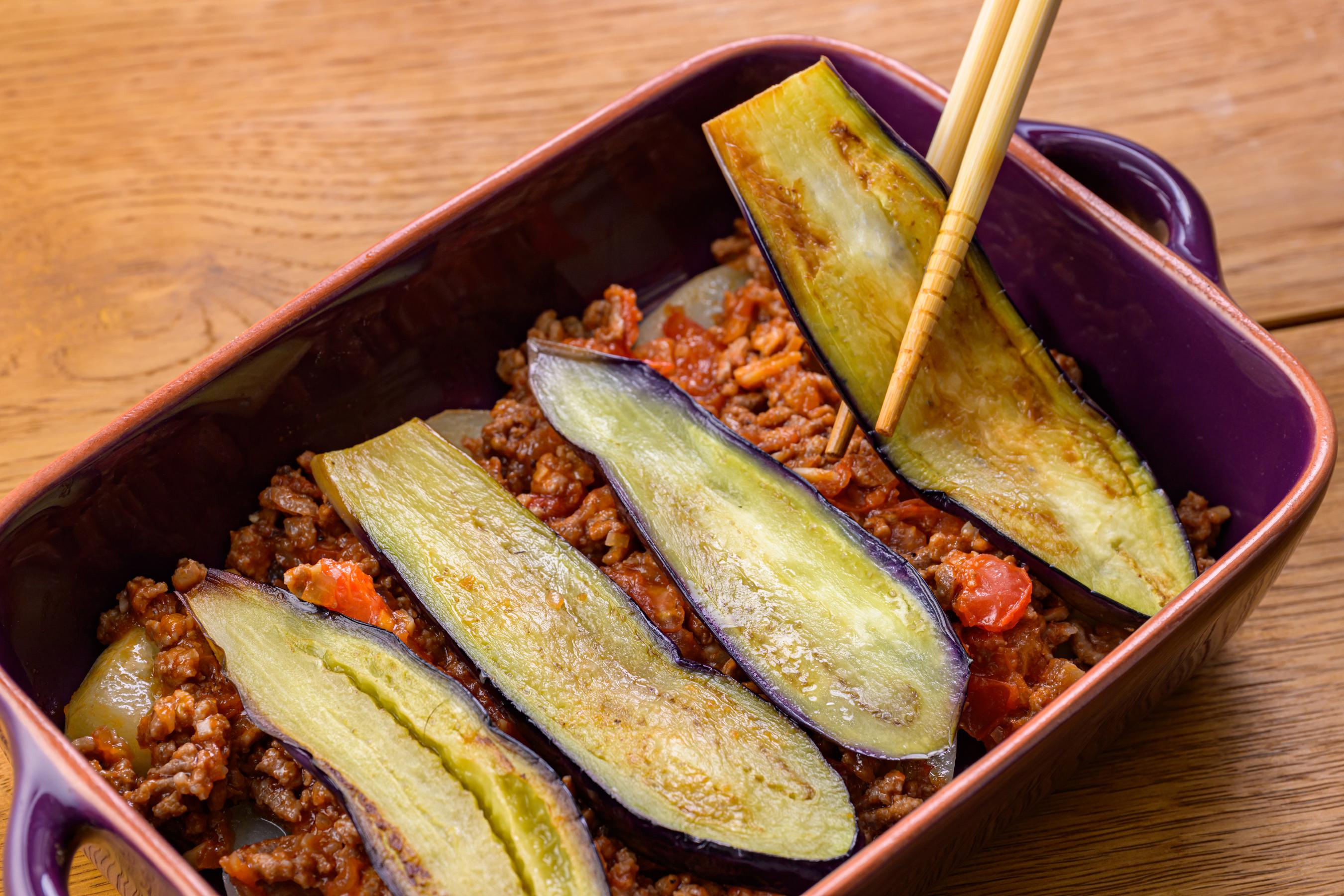 Layering eggplant over meat sauce