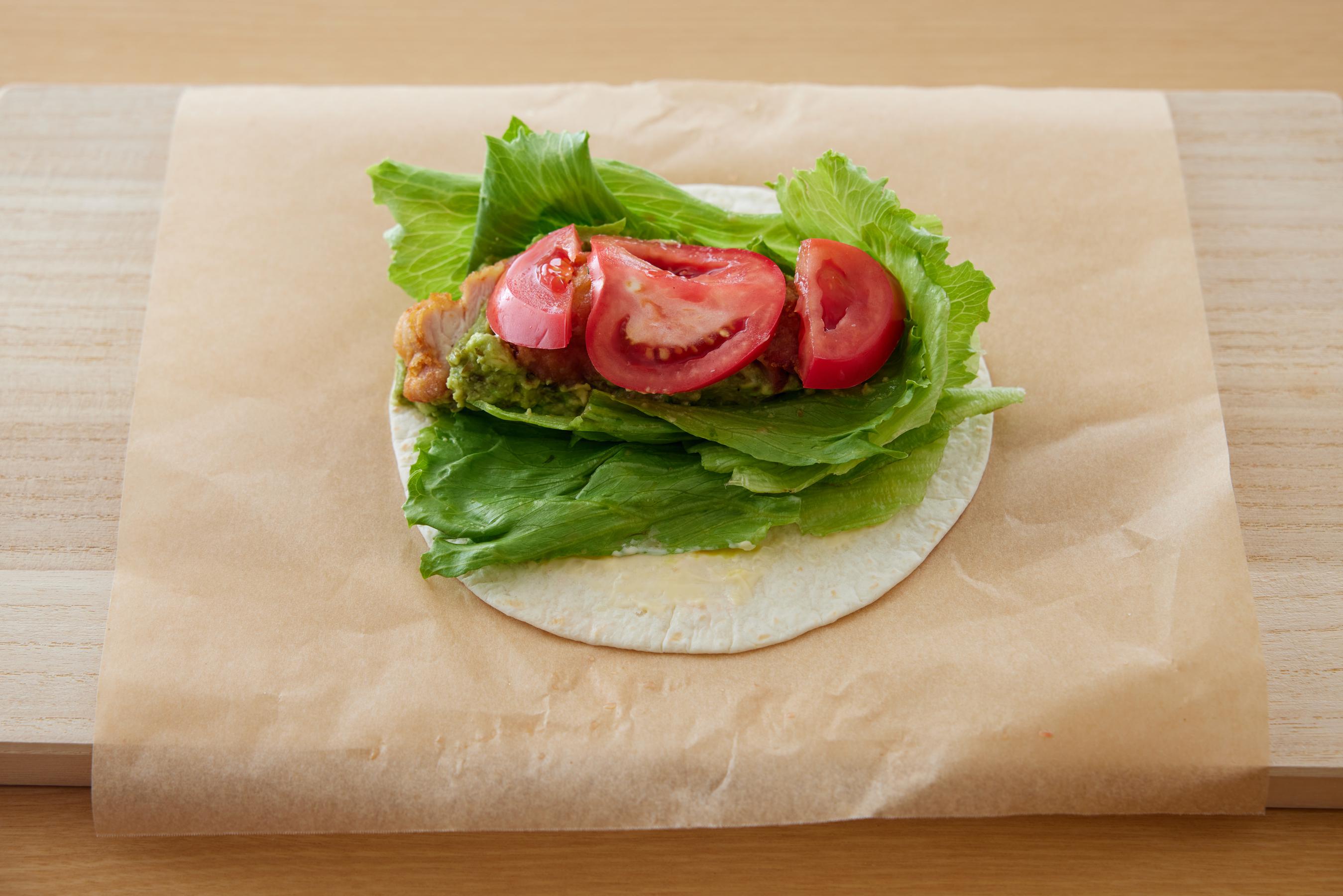 ingredients being spread on a tortilla