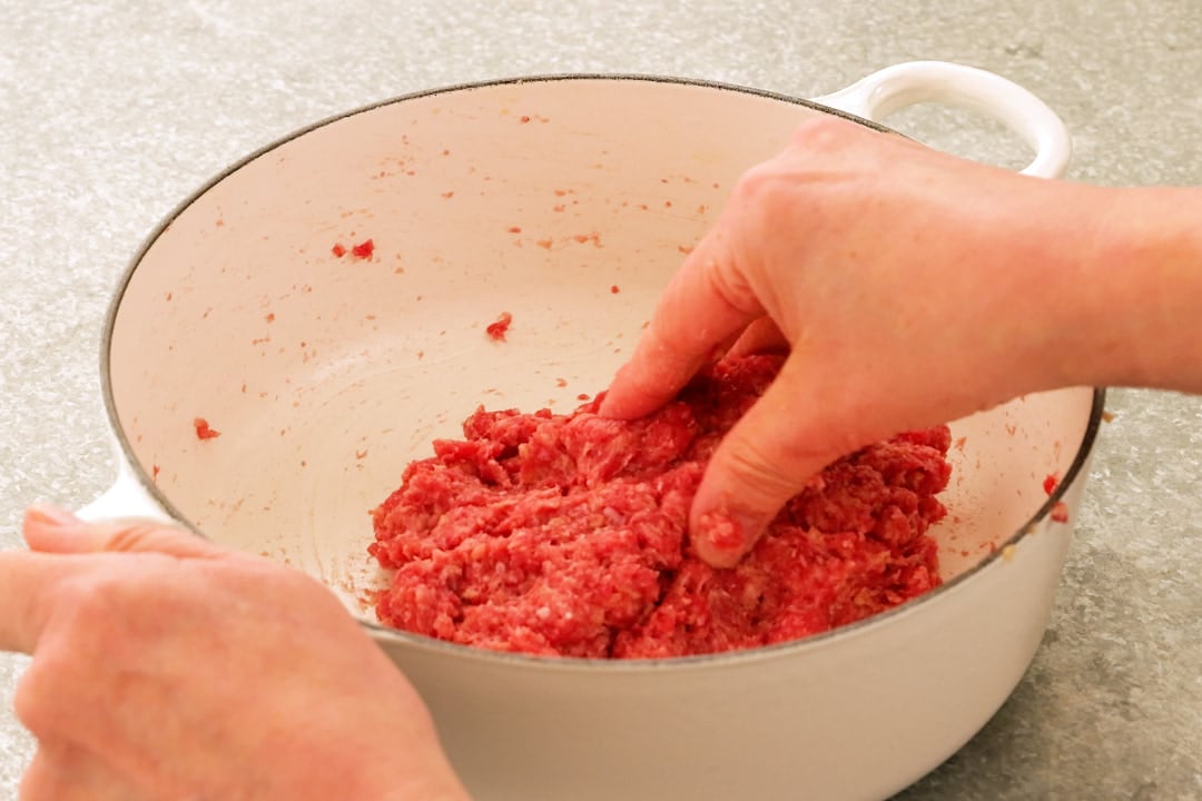 Mixing ground meat in a pot