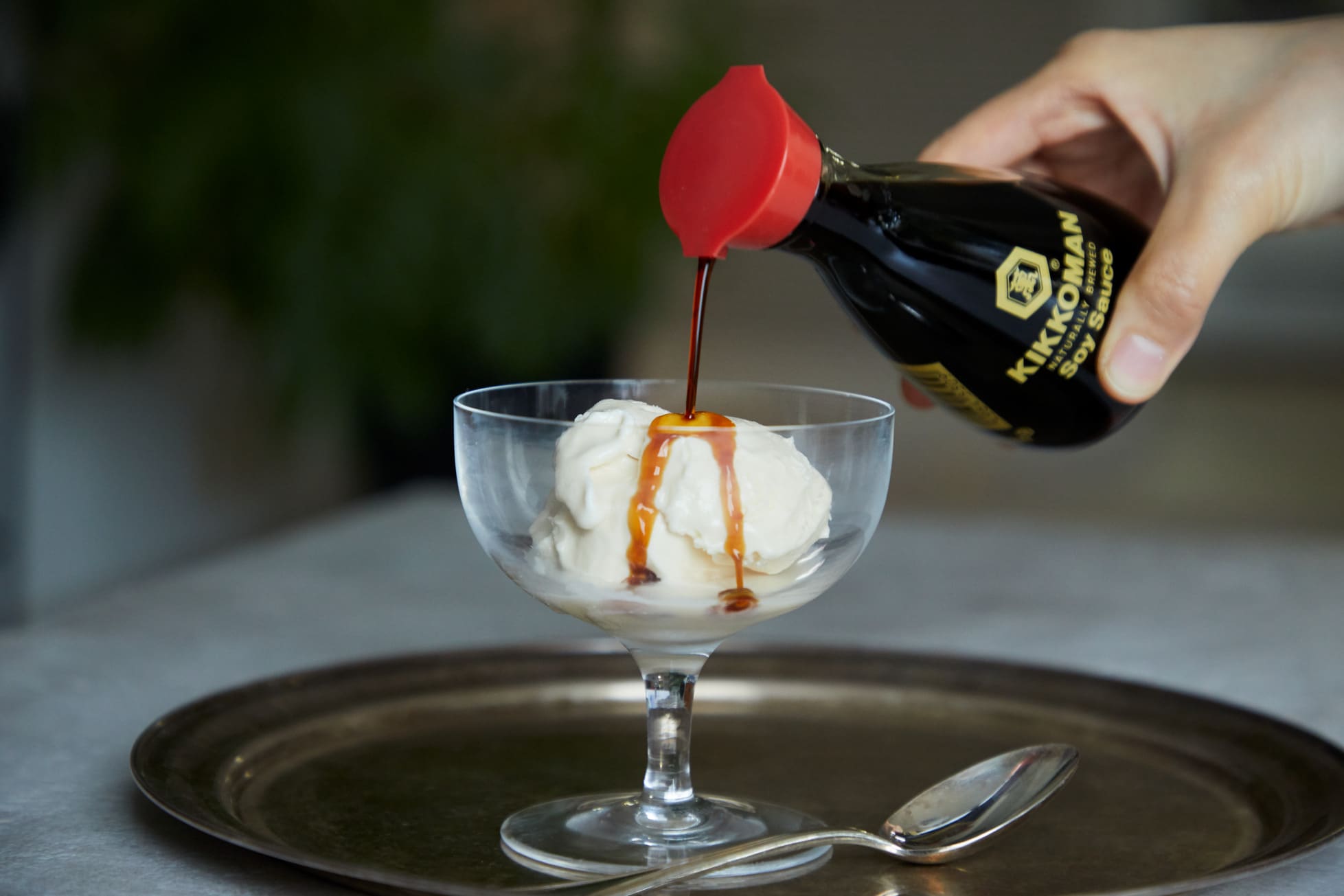 Pouring soy sauce over ice cream