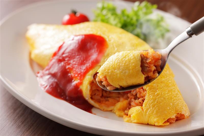 Japanese egg Omurice with ketchup, fluffy omelette and rice