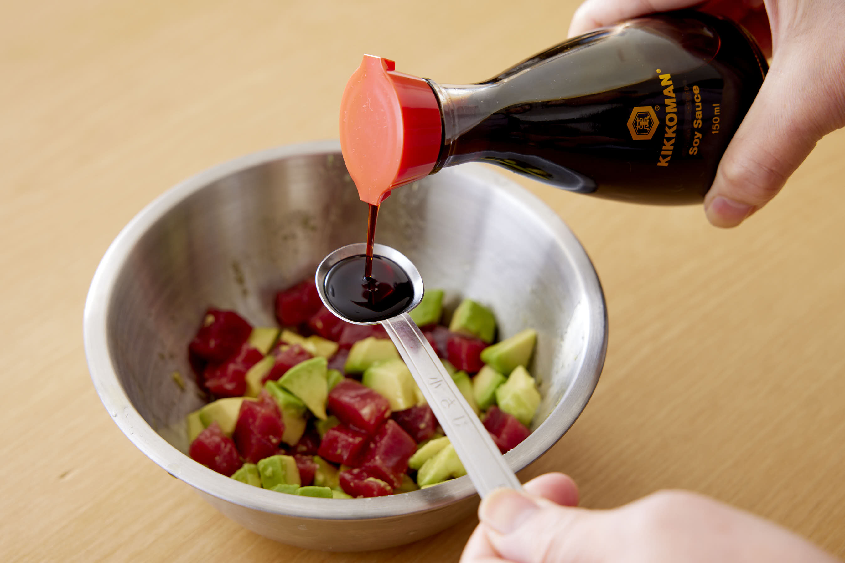 Adding Kikkoman Soy Sauce