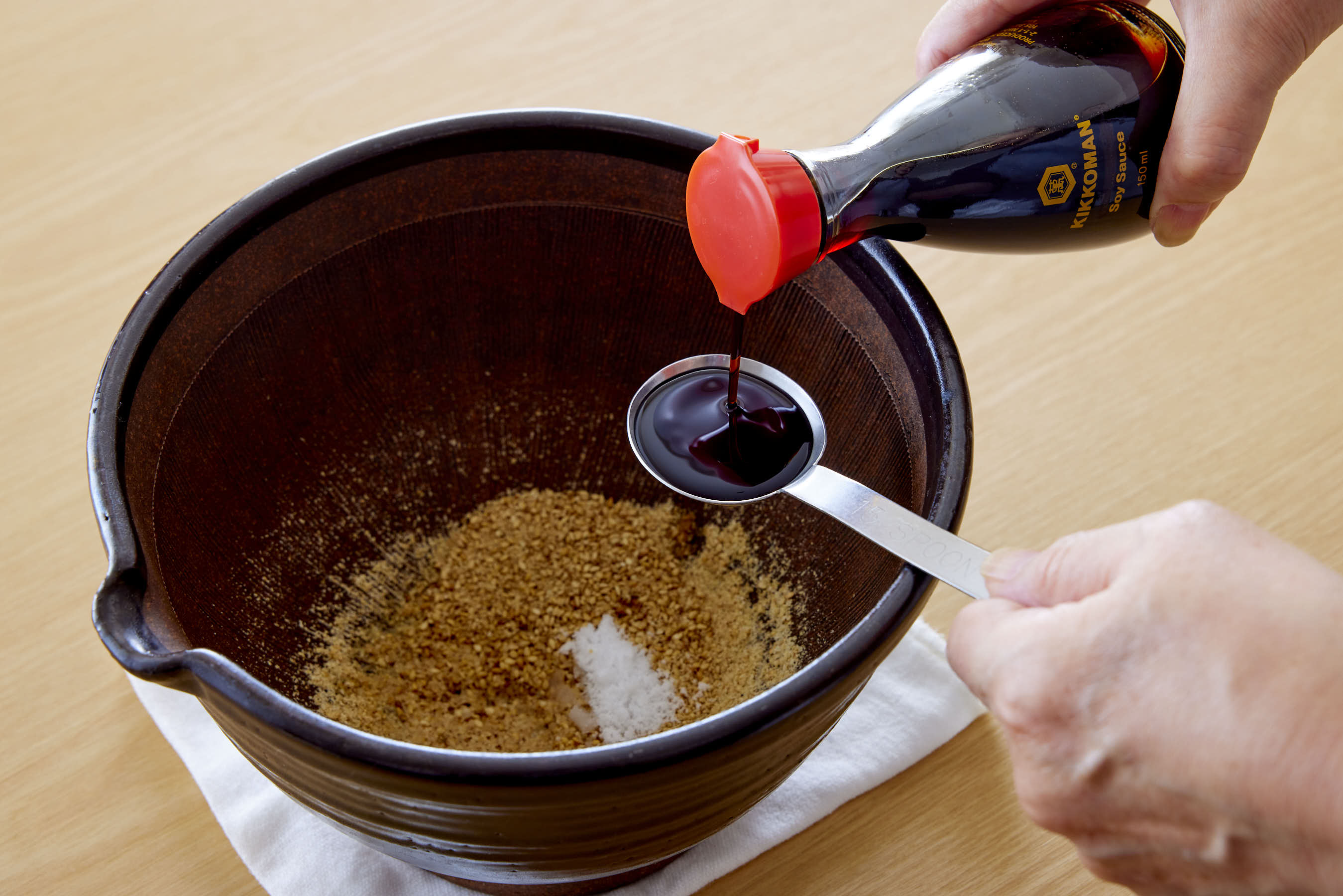 Adding Kikkoman Soy Sauce