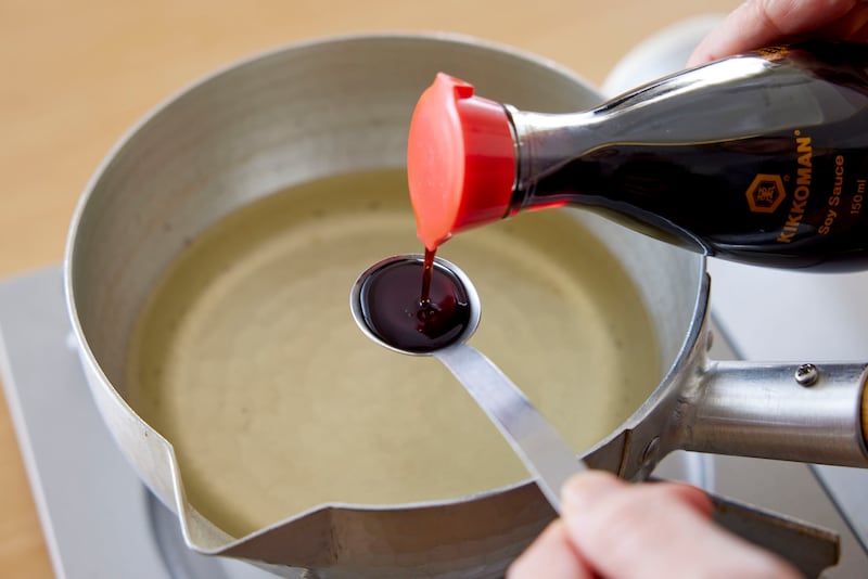 Adding Kikkoman Soy Sauce