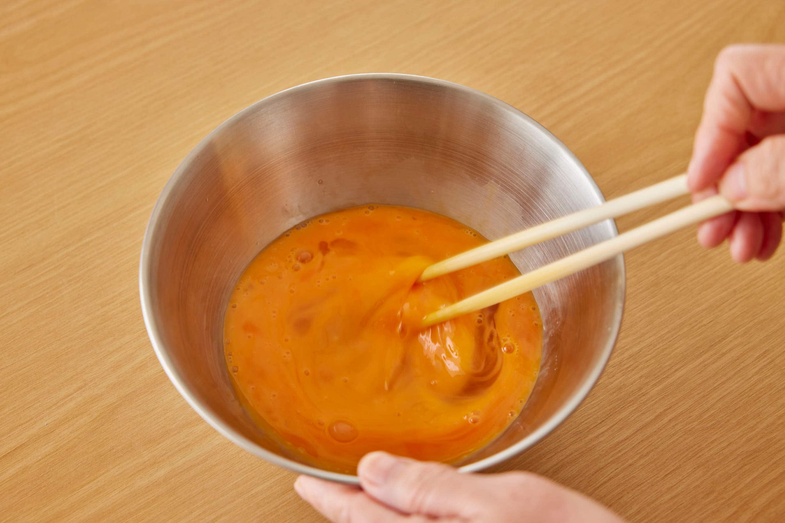 Beating the eggs in a bowl