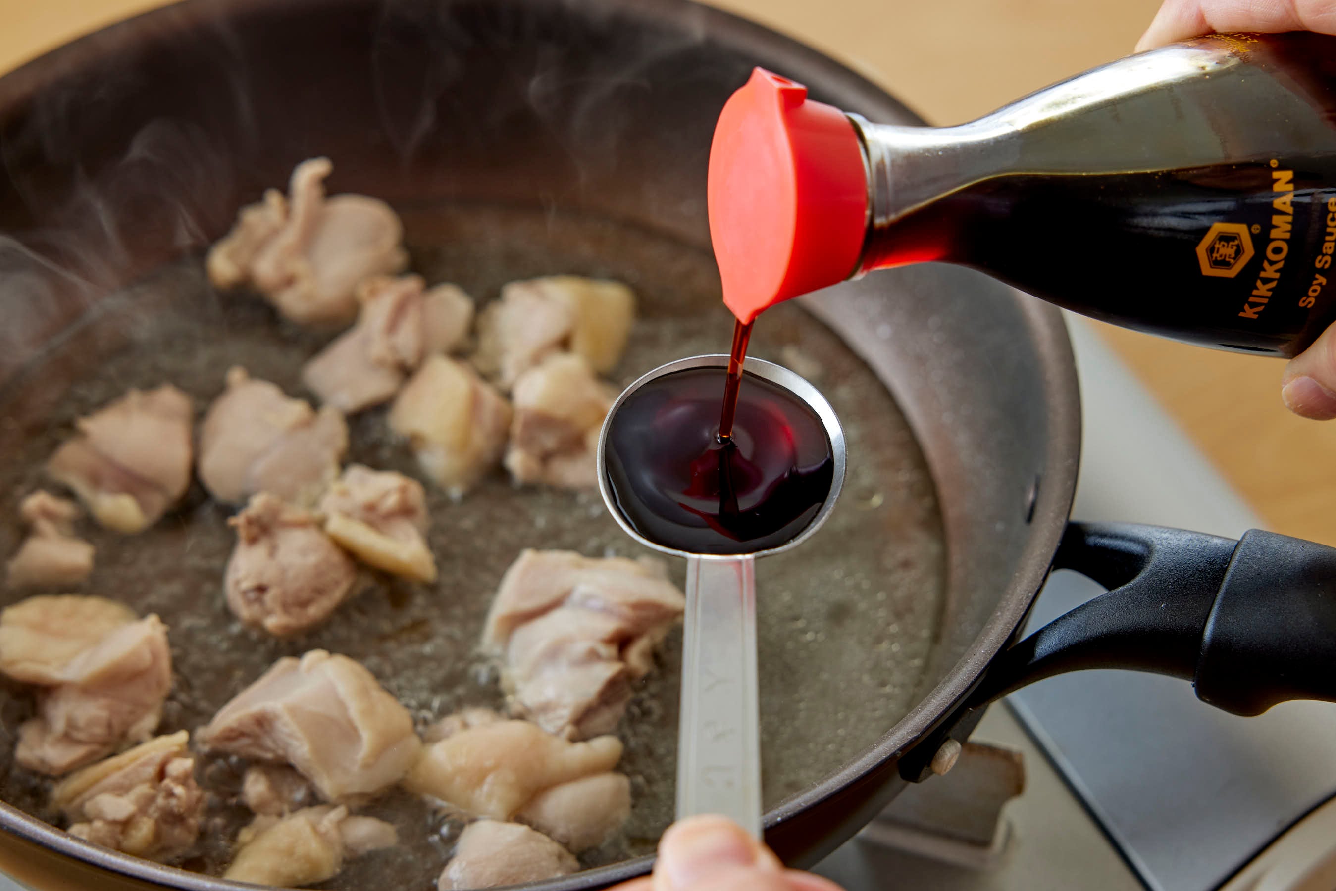 Adding Kikkoman Soy Sauce