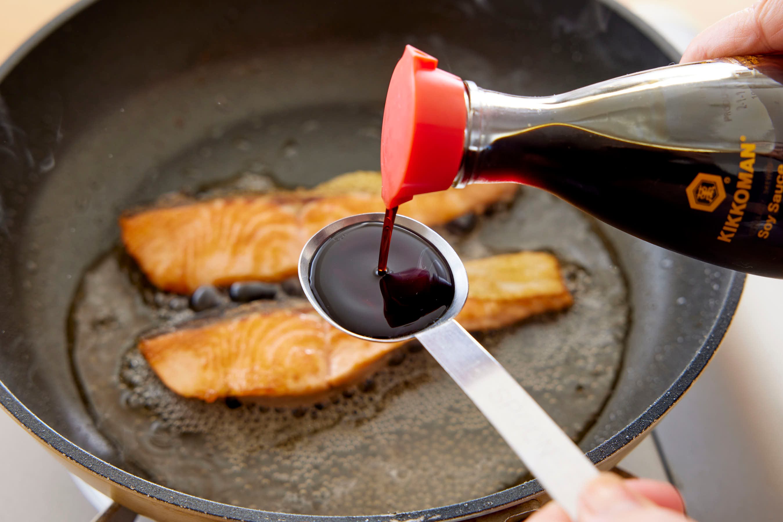 Adding Kikkoman Soy Sauce