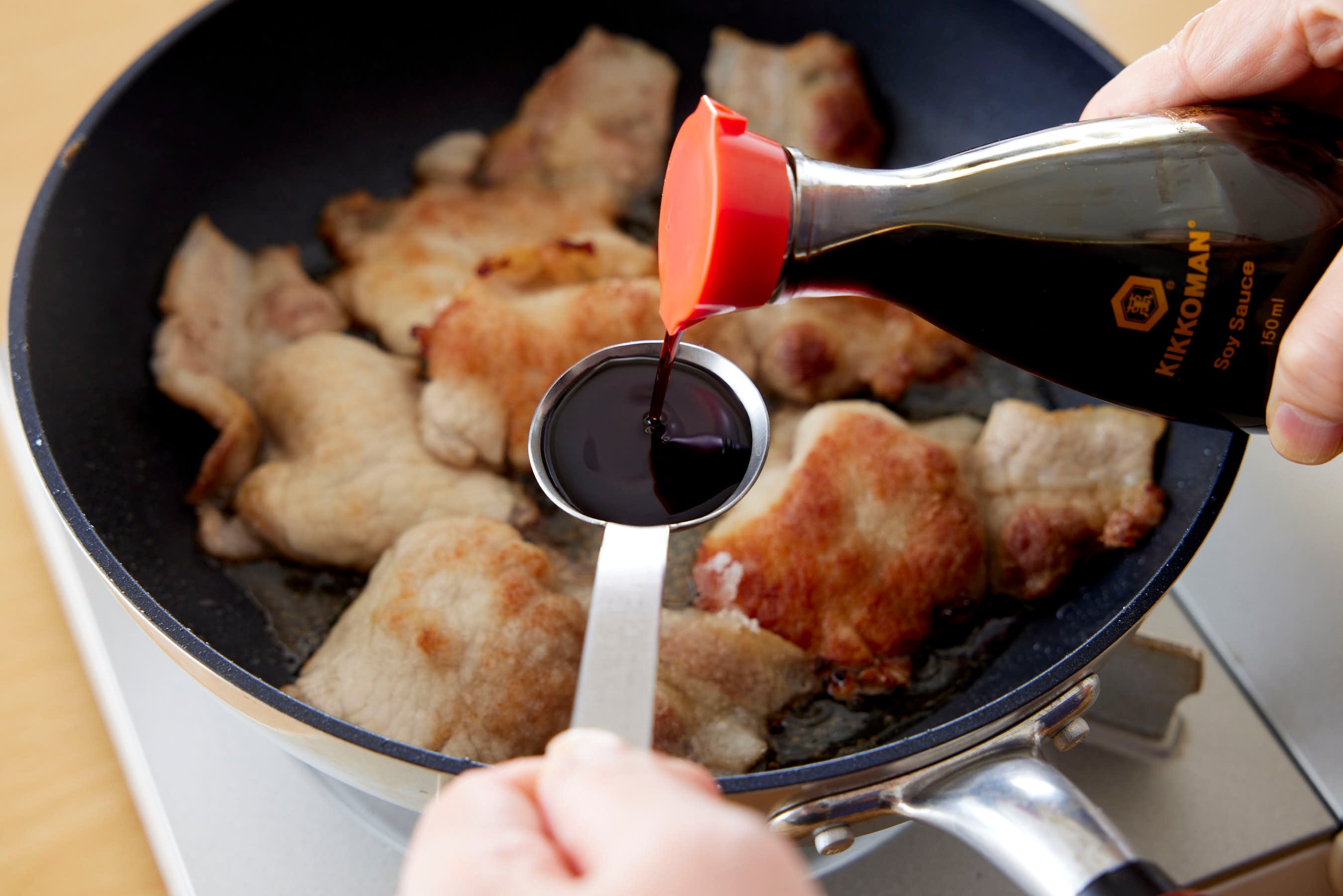 Adding Kikkoman Soy Sauce