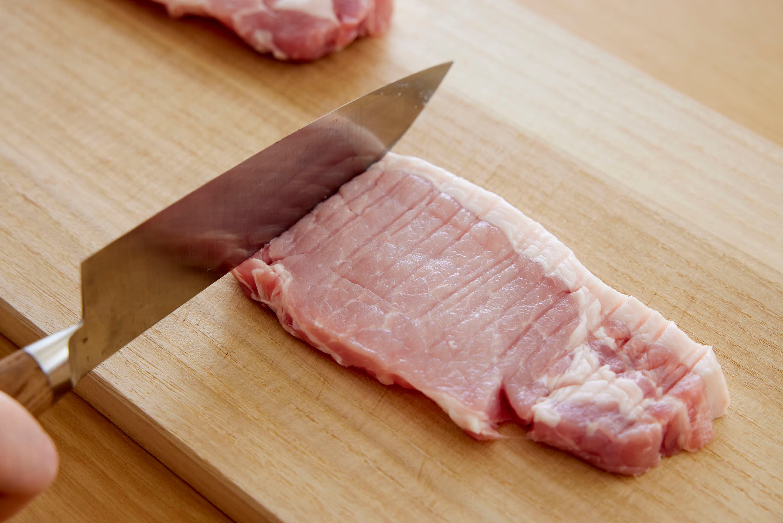 Pounding the entire surface of the pork