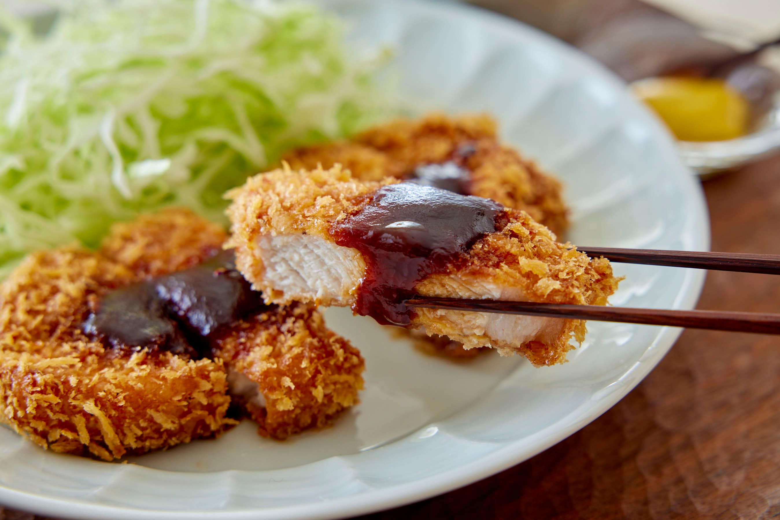 Picking up tonkatsu with chopsticks