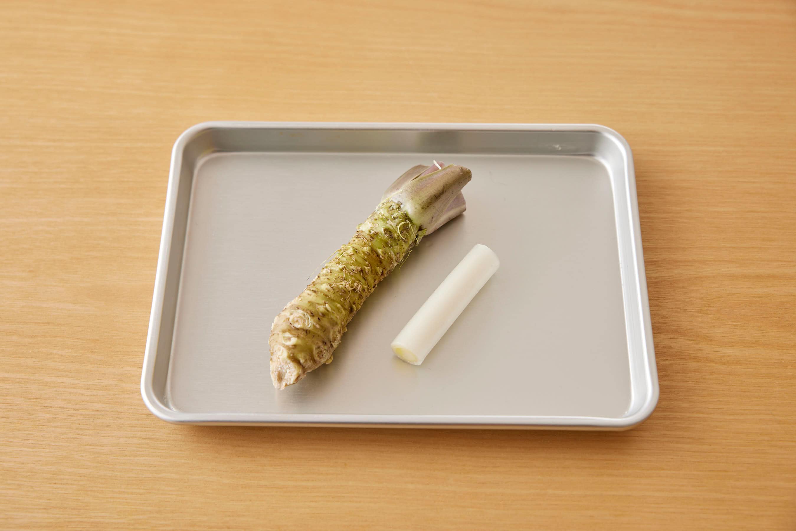 Fresh wasabi and Japanese long green onion on a trey