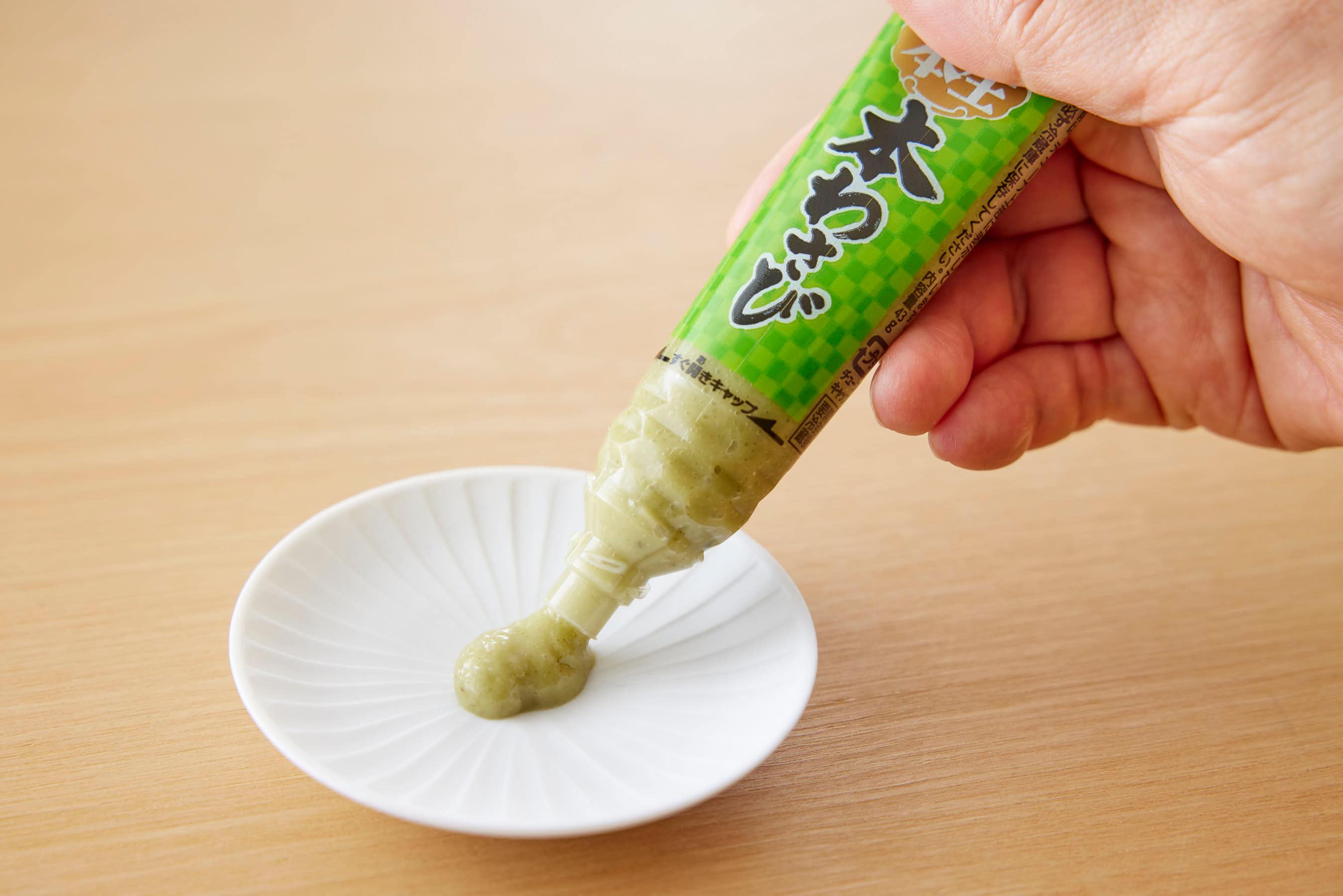Squeezing grated wasabi out of the tube