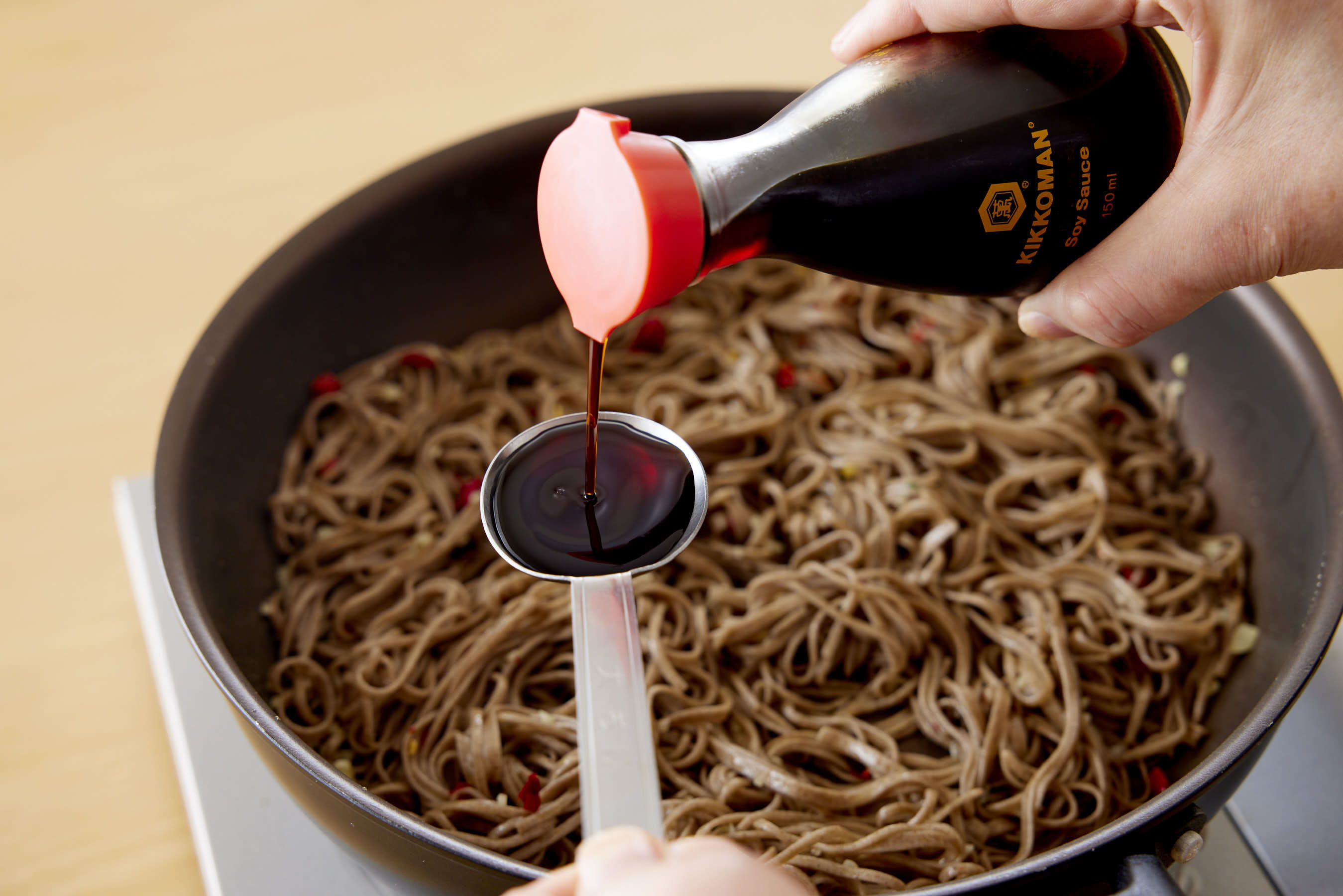 Adding Kikkoman Soy Sauce