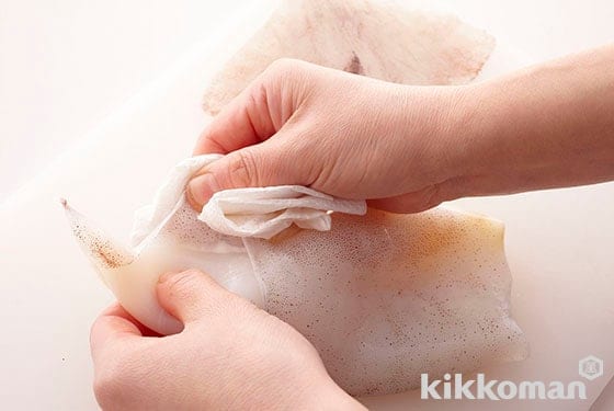 Starting where you removed the wings, peel off the skin by peeling around and off sideways as opposed to lengthwise. If you use a dry paper towel to grab onto the skin it will not slip in your fingers and peeling off will be easier.
