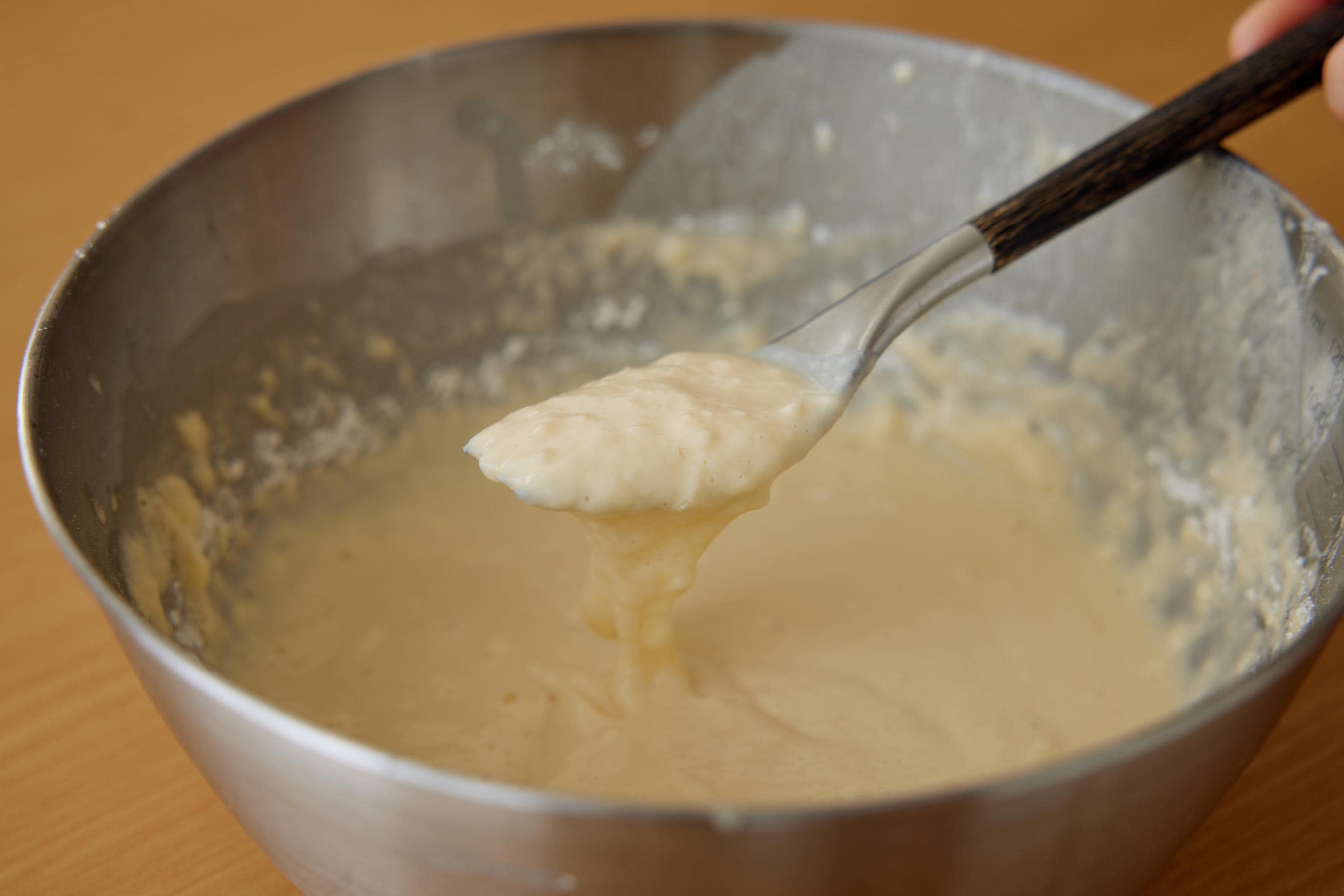 Adding flour and sugar into batter.
